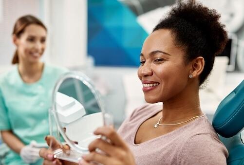 emergency dentist open late | woman at dentist