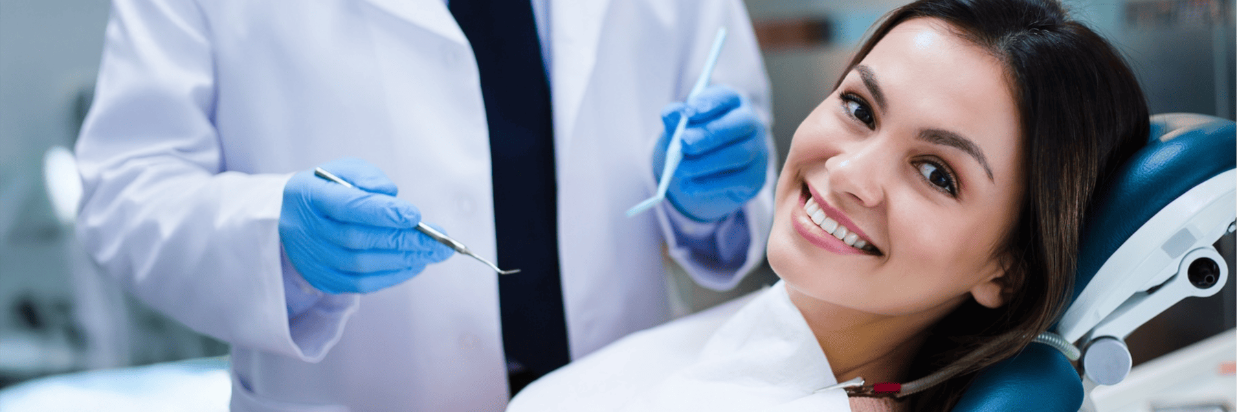 Smiling woman in dental chair during emergency dental visit Milwaukee