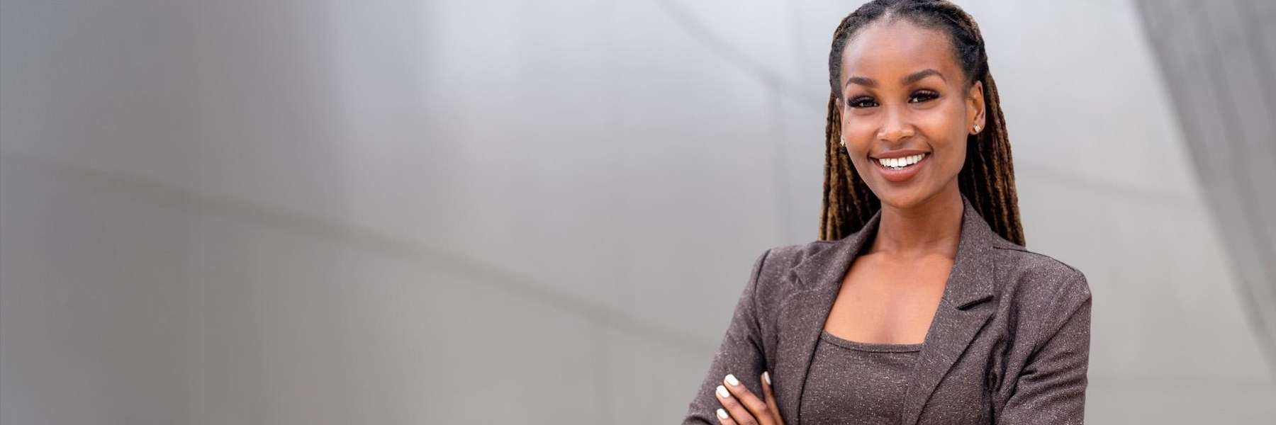 Black woman smiling with arms crossed, west allis wi