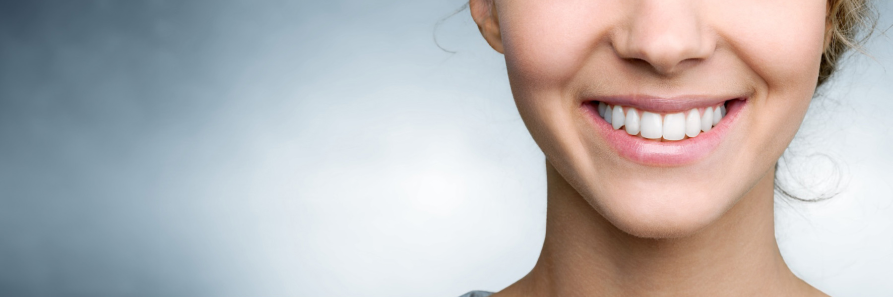 Woman smiling with healthy white teeth, representing oral health care in West Allis