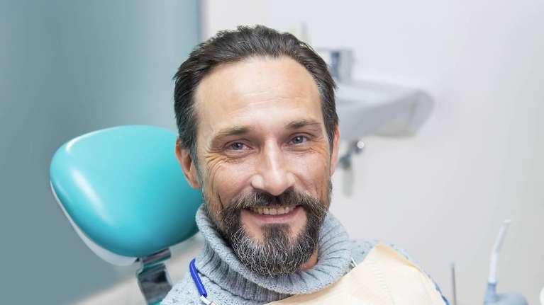 tooth replacement west allis | man at dentist